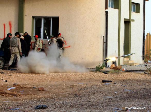 Soldiers of Libya's National Transitional Council (NTC) fire at Gaddafi loyalists in Bani Walid, Libya, Oct. 9, 2011. The head of the ruling Libyan National Transitional Council (NTC) Mustafa Abdel-Jalil said Sunday that it is possible to end the battles next week in Bani Walid and Sirte, the only remaining strongholds of fallen leader Muammar Gaddafi. [Hamza Turkia/Xinhua] 