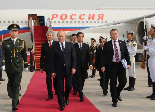 Russian Prime Minister Vladimir Putin (2nd L, front) arrives in Beijing for an official visit to China, Oct. 11, 2011. During the visit, Putin will attend the 16th regular meeting between the two countries' premiers. [Rao Aimin/Xinhua]