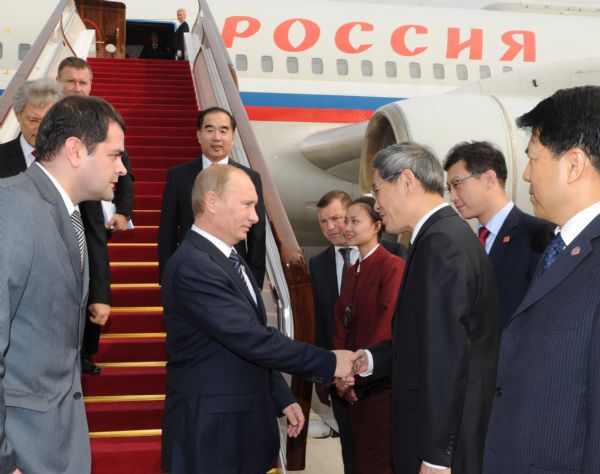 Russian Prime Minister Vladimir Putin (2nd L, front) is greeted upon his arrival in Beijing for an official visit to China, Oct. 11, 2011. During the visit, Putin will attend the 16th regular meeting between the two countries' premiers. [Rao Aimin/Xinhua] 