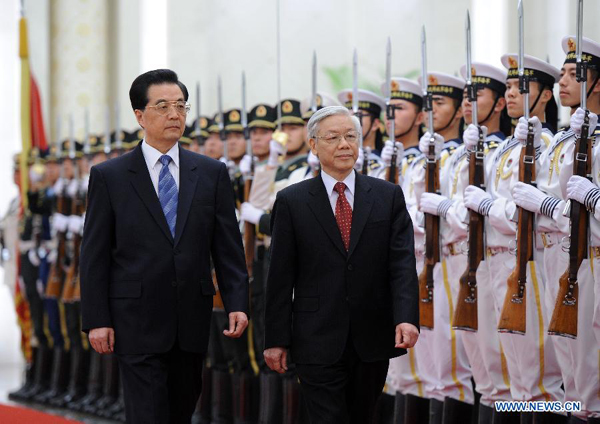 Chinese President Hu Jintao (L, front), who is also general secretary of the Central Committee of the Communist Party of China, and General Secretary of the Communist Party of Vietnam Central Committee Nguyen Phu Trong (R, front) inspect guards of honor during a welcome ceremony in Beijing, Oct. 11, 2011. Nguyen Phu Trong arrived in Beijing on Tuesday, kicking off a five-day official visit to China.