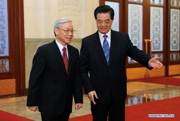 Chinese President Hu Jintao (R), who is also general secretary of the Central Committee of the Communist Party of China, meets with General Secretary of the Communist Party of Vietnam Central Committee Nguyen Phu Trong during a welcome ceremony in Beijing, Oct. 11, 2011. Nguyen Phu Trong arrived in Beijing on Tuesday, kicking off a five-day official visit to China.
