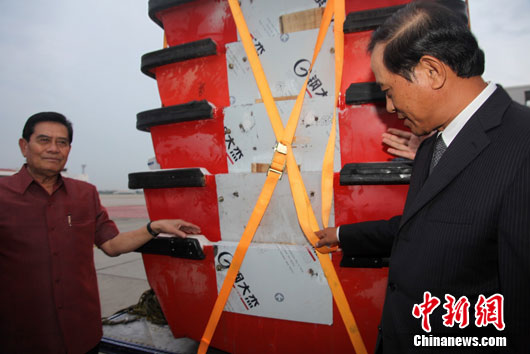 A chartered cargo plane carrying 45 tons of flood-relief supplies donated by the Chinese government arrives at the Don Mueang Airport of Bangkok on Oct. 12, 2011. In the picture Chinese ambassador to Thailand Guan Mu (right) turns over the relief supplies to the Thailand side. 