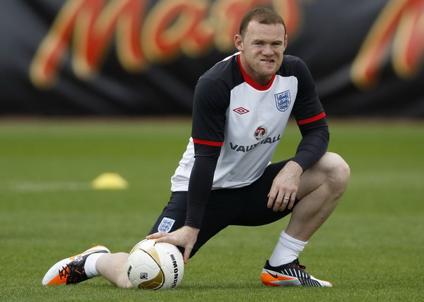 England's Wayne Rooney attends a team training session in London Colney, north of London in this Oct 4, 2011 file photo. Rooney has been given a three-match international ban by UEFA for his sending-off against Montenegro on Oct 7, 2011, ruling him out of the group stage of Euro 2012. [Agencies]