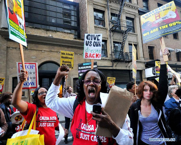Protestors chant slogans during a demonstration in San Francisco, the U.S., on Oct. 12, 2011. Hundreds of protestors attended the demonstration here on Wednesday to respond the Occupy Wall Street protest and to protest against the high umemployment rate and the wide gap between the rich and the poor. [Liu Yilin/Xinhua]