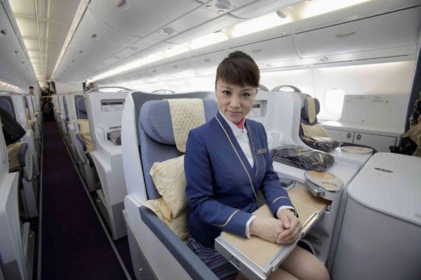 An air hostess sits in the passenger cabin of the first Airbus A380 delivered to China Southern Airlines during a ceremony at the Airbus Delivery Center in Colomiers near Toulouse October 14, 2011. [Photo/Agencies]