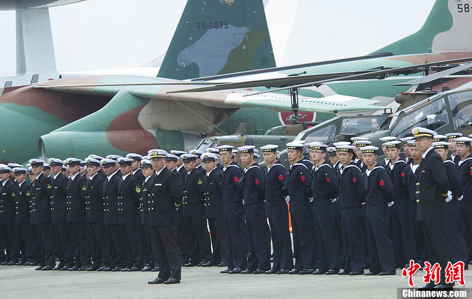 Soldiers stand beside planes on display during Japan's Air Self Defense Force parade in Ibaraki Prefecture Barry base