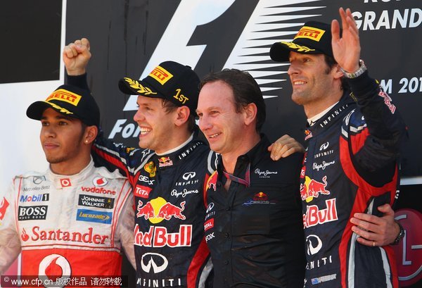 Race winner Sebastian Vettel (2nd left) of Germany celebrates with his team Principal Christian Horner (2nd right), second placed Lewis Hamilton (left) of Great Britain and third placed Mark Webber (right) of Australia following the Korean Formula One Grand Prix at the Korea International Circuit on October 16, 2011 in Yeongam-gun, South Korea.