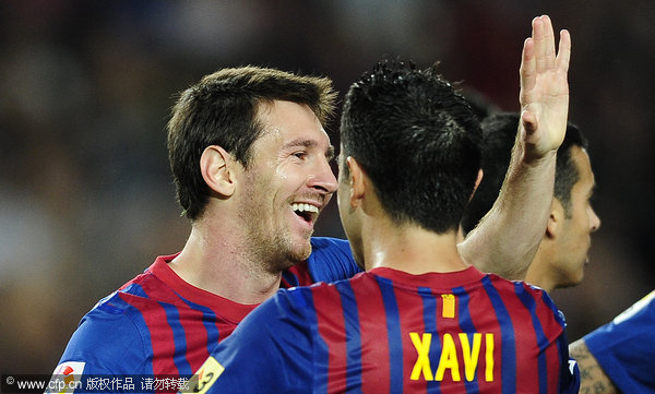 FC Barcelona's Lionel Messi (left) reacts after scoring his second goal against Racing Santander during a Spanish La Liga soccer match at the Camp Nou stadium in Barcelona on Saturday, Oct. 15, 2011.