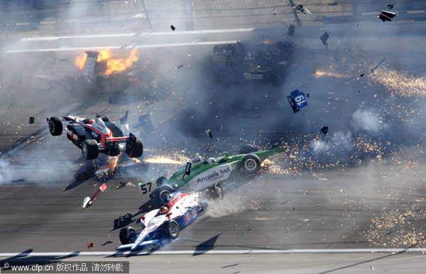 Drivers crash during a wreck that involved 15 cars during the IndyCar Series' Las Vegas Indy 300 Auto Race at Las Vegas motor speedway in on Sunday, Oct. 16, 2011. 