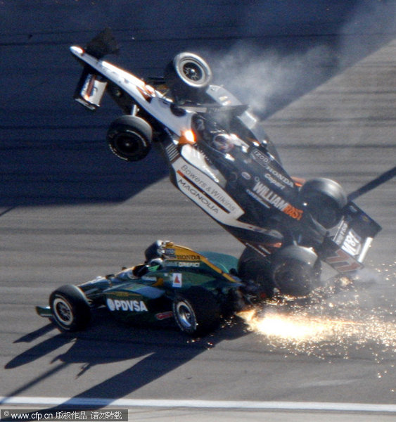 Dan Wheldon (77) goes airborne during a wreck that involved 15 cars in the IndyCar Series' Las Vegas Indy 300 Auto Race at Las Vegas motor speedway on Sunday, Oct. 16, 2011. Wheldon died following the crash.