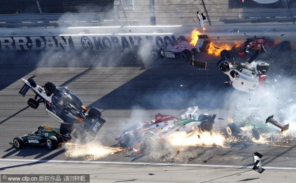 Drivers crash during a wreck that involved 15 cars during the IndyCar Series' Las Vegas Indy 300 Auto Race at Las Vegas motor speedway in on Sunday, Oct. 16, 2011.