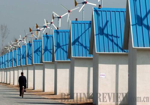 Nature's power: A vegetable greenhouse in central China's Henan Province uses wind power for lighting and major power supply. Clean energy and new technologies are being introduced to propel local economic development [By Wang Song/Beijing Review] 
