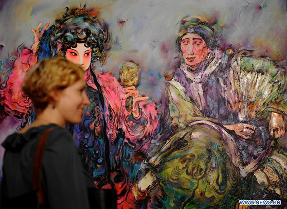 A woman visits the Selected Works of Chinese Oil Paintings Exhibition at the UN headquarters in New York, Oct. 17, 2011. More than 20 works of Chinese artist Liu Linghua were shown at the exhibition, which would last from Oct. 17 to 27. 