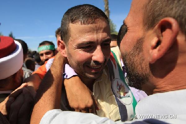 Palestinian prisoners who were released from Israeli jail meet with their families after they entered the Gaza Strip through Rafah border crossing near Rafah City, Oct. 18, 2011. Israel started releasing Palestinian prisoners on Tuesday in exchange for Israeli soldier Gilad Shalit, according to a swap deal reached between Israel and Hamas. [Chen Xu/Xinhua]