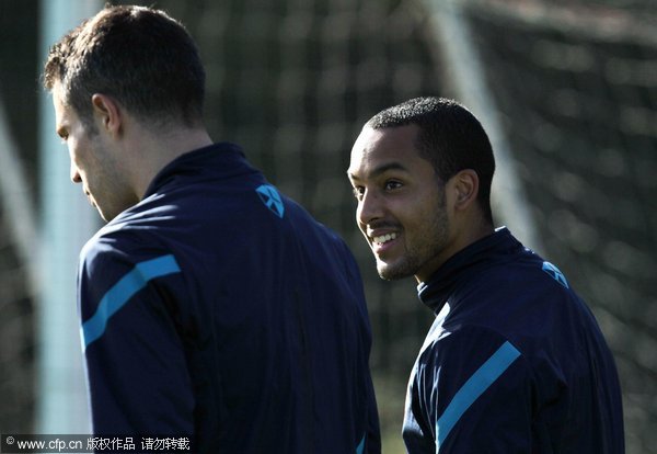 Theo Walcott (R) and Robin van Persie of Arsenal attend a training session ahead of their UEFA Champions League Group F match against Olympique de Marseille at London Colney on October 18, 2011 in St Albans, England.