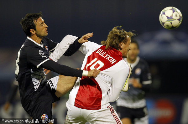 Ajax's Dmitri Bulykin (right) is challenged by Dinamo Zagreb's Mario Situm during their Champions League Group D soccer match at Maksimir stadium in Zagreb, Croatia on Tuesday, Oct. 18, 2011.