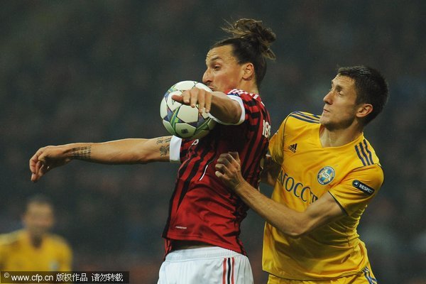 Zlatan Ibrahimovic of AC Milan competes with Artyom Radkov of FC BATE Borisov during the UEFA Champions League group H match between AC Milan and FC BATE Borisov at Giuseppe Meazza Stadium on October 19, 2011 in Milan, Italy. 