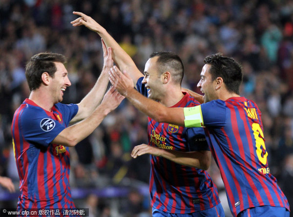 FC Barcelona's Andres Iniesta (center) celebrates with teammates Lionel Messi (left) and Xavi Hernandez after scoring during a Champions League Group H soccer match against Viktoria Plzen at the Camp Nou in Barcelona, spain on Wednesday, Oct. 19, 2011.