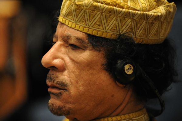 File photo taken on Feb. 2, 2009 shows Muammar Gaddafi reacting during the opening ceremony of the 12th AU Summit in Addis Ababa, capital of Ethiopia. [Xu Suhui/Xinhua]