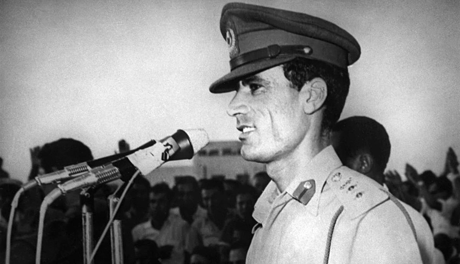 Former Libyan leader Muammar Gaddafi[L] when he is young 