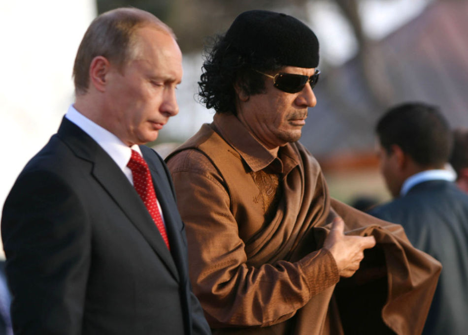 Former Libyan leader Muammar Gaddafi and Russian Prime Minister Vladimir Putin