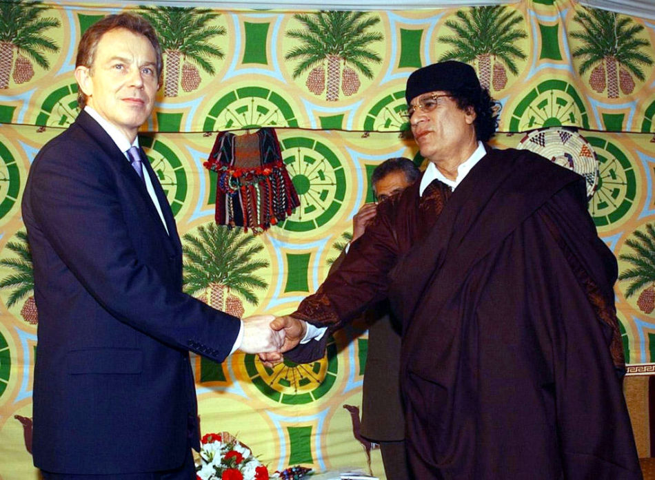 Former Libyan leader Muammar Gaddafi and former British Prime Minister Tony Blair