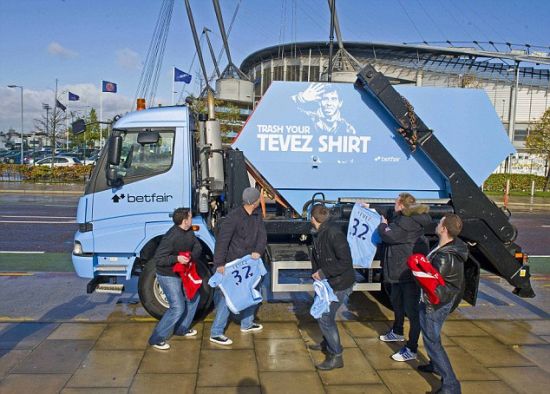 Fans discard their Carlos Tevez shirts in a skip outside Old Trafford.