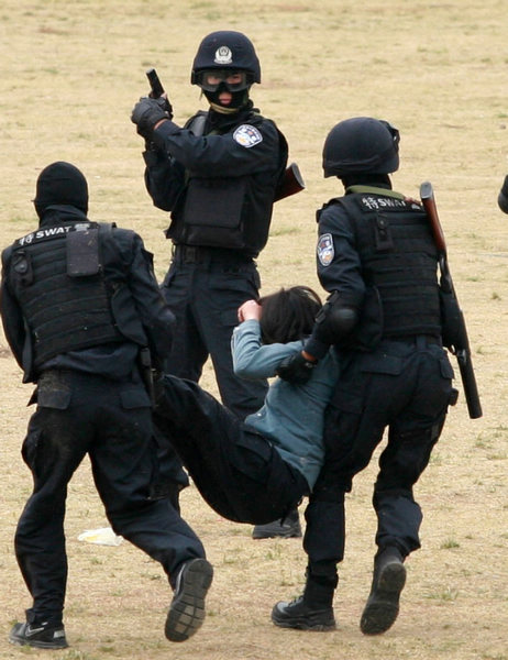 SWAT officers rescue a 'hostage' in the drill. [Jin Zhenqiang / for China Daily] 