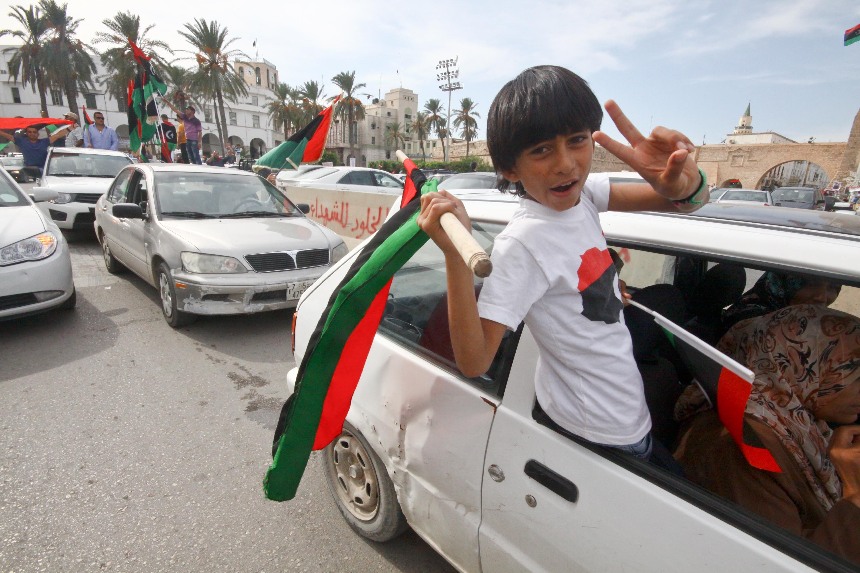 People in Tripoli, capital of Libya celebrate the news that former leader Col. Muammar Gaddafi has been killed in Sirte. [Xinhua]
