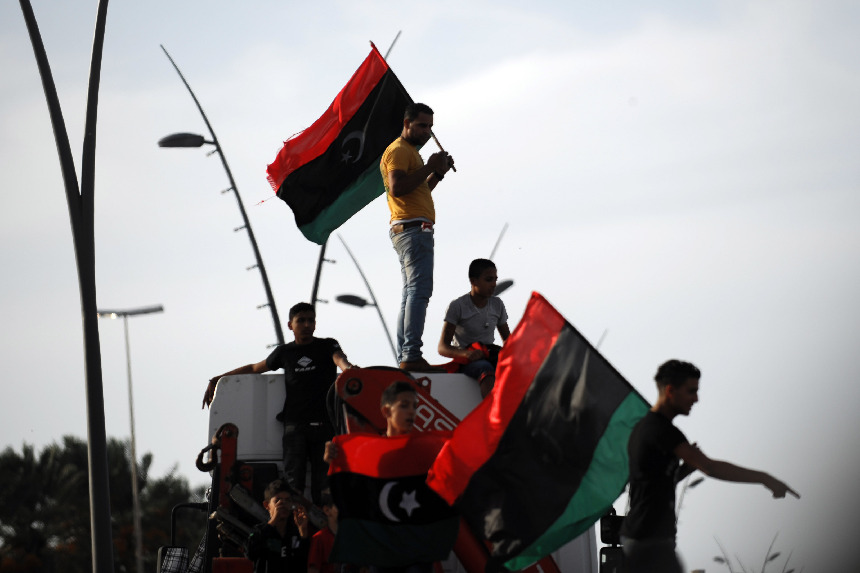 People in Tripoli, capital of Libya, celebrate the news that former leader Col. Muammar Gaddafi has been killed in Sirte. [Xinhua]