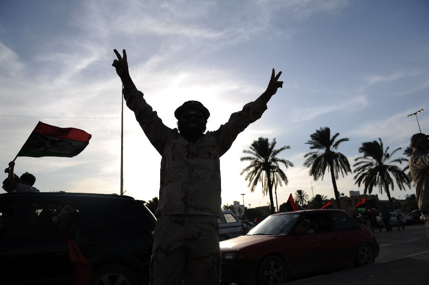 People in Tripoli, capital of Libya, celebrate the news that former leader Col. Muammar Gaddafi has been killed in Sirte. [Xinhua]