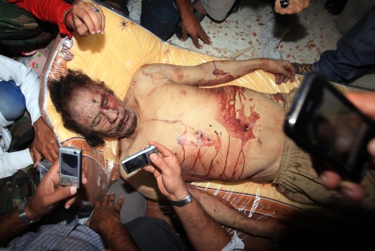 The photo taken on Oct. 21, 2011 shows the body of former Libyan leader Muammar Gaddafi in Misrata, Libya. 