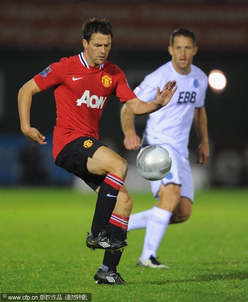 Michael Owen of Manchester United in action with Darren Jones of Aldershot during the Carling Cup fourth round match between Aldershot Town and Manchester United at the EBB Stadium, Recreation Ground on October 25, 2011 in Aldershot, England.