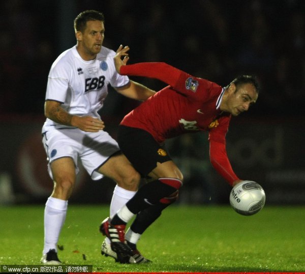 Dimitar Berbatov of Manchester United clashes with Darren Jones of Aldershot Town during the Carling Cup fourth round match between Aldershot Town and Manchester United at the EBB Stadium on October 25, 2011 in Aldershot, England. 