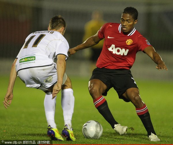  Antonio Valencia of Manchester United clashes with Alex Rodman of Aldershot Town during the Carling Cup fourth round match between Aldershot Town and Manchester United at the EBB Stadium on October 25, 2011 in Aldershot, England. 