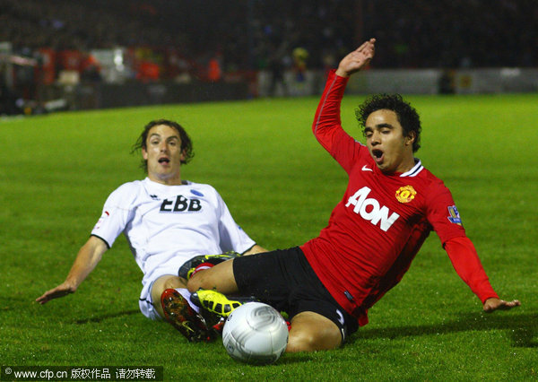 Aldershot Town's Danny Hylton (left) and Manchester United's Fabio Da Silva battle for the ball during the Carling Cup, Fourth Round match at The EBB Stadium, Aldershot.