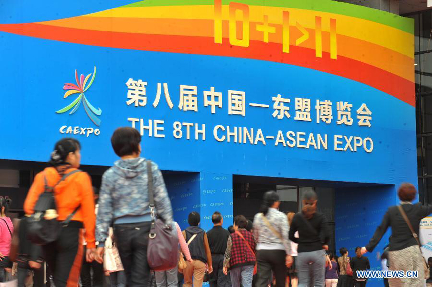 Visitors walk into the Nanning International Exhibition Center, one of the venues of the 8th China-ASEAN Expo, in Nanning, capital of southwest China's Guangxi Zhuang Autonomous Region, Oct. 26, 2011. The 6-day event, which attracted 2,300 enterprises from China and 11 ASEAN countries, closed on Wednesday, with a total transaction volume of 1.8 billion US dollars.