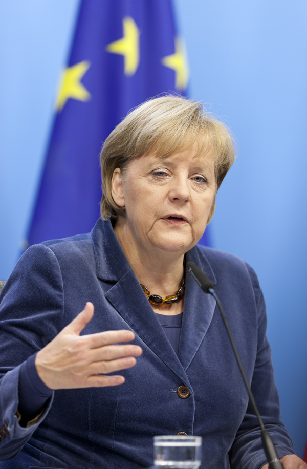 German Chancellor Angela Merkel attends a press conference after an EU summit in Brussels, capital of Belgium, on Oct. 27, 2011. European leaders announced early Thursday morning that a long-awaited rescue plan to fight the euro debt crisis has been reached, which included a 50 percent writedown on the value of the Greek bonds held by private investors. 