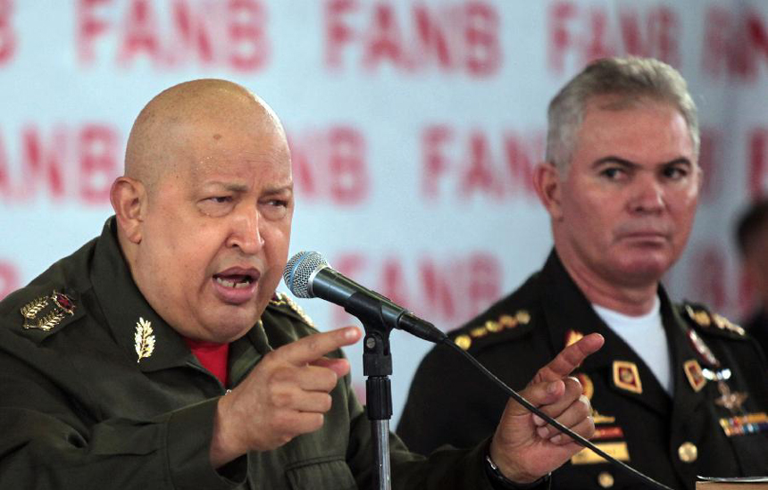 Image provided by Venezuelan Presidency shows President Hugo Chavez (L) delivering a speech next to Defense Minister Carlos Mata Figueroa (R), during a conference at Tiuna Fort, in Caracas, capital of Venezuela, on Oct. 26, 2011.