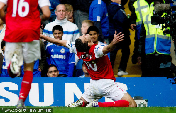 Arsenal's Robin van Persie celebrates his hattrick against Chelsea during their English Premier League soccer match at the Stamford Bridge ground in London on Saturday, Oct. 29, 2011. 