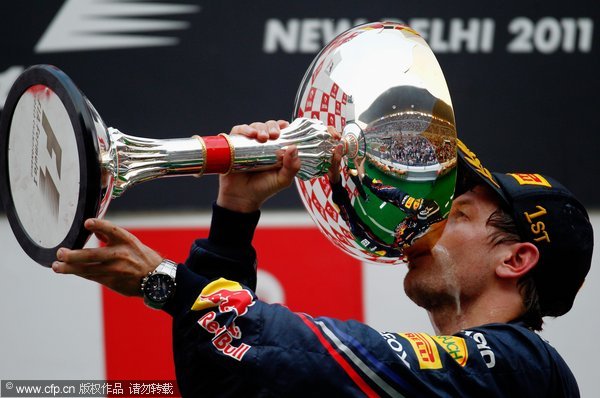 Sebastian Vettel of Germany and Red Bull Racing celebrates on the podium after winning the Indian Formula One Grand Prix at the Buddh International Circuit on October 30, 2011 in Noida, India. 