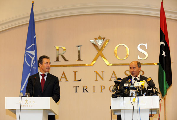 NATO Secretary-General Anders Fogh Rasmussen (L) and Chairman of the Libyan National Transitional Council Mustafa Abdul Jalil attend the press conference after their meeting in Tripoli, Libya, Oct. 31, 2011. Rasmussen visited Libya on Monday and hailed the end of the alliance's military intervention in Libya. 