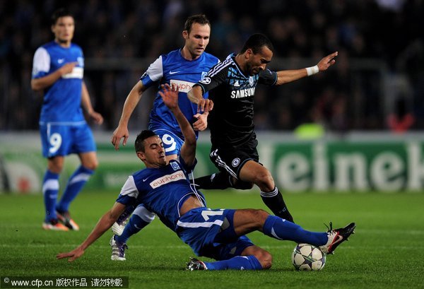  Jose Bosingwa of Chelsea is tackled by Fabien Camus of KRC Genk during the UEFA Champions League Group E match between KRC Genk and Chelsea at the KRC Genk Arena on November 1, 2011 in Genk, Belgium.