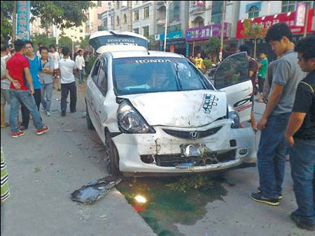 The wrecked car of Ling Huakun, a citizen in Wuchuan city, South China's Guangdong province, who drove his car to chase robbers in May, but accidentally killed one of the two robbers and wounded another.