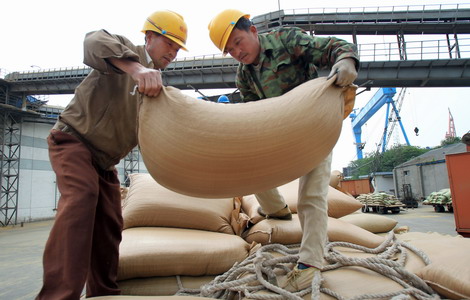 Workers unload imported soybeans at a port in China. The country imported 5.35 million tons of soybeans.