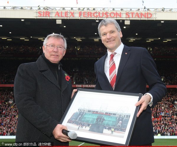 Sir Alex Ferguson (L) of Manchester United poses with Chief Executive David Gill on the occasion of the 25th anniversary of his appointment as Manchester United manager ahead of the Barclays Premier League match between Manchester United and Sunderland at Old Trafford on November 5, 2011 in Manchester, England.