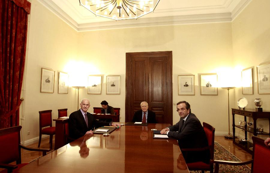 Greece's Prime Minister George Papandreou, left, Greek President Karolos Papoulias, center and opposition leader Antonis Samaras sit at the Presidential Palace in Athens on Sunday, Nov. 6, 2011. Greek Prime Minister George Papandreou and opposition leader Antonis Samaras have agreed on a new coalition government to approve a euro zone bailout deal before elections, the office of the country's president said on Sunday.