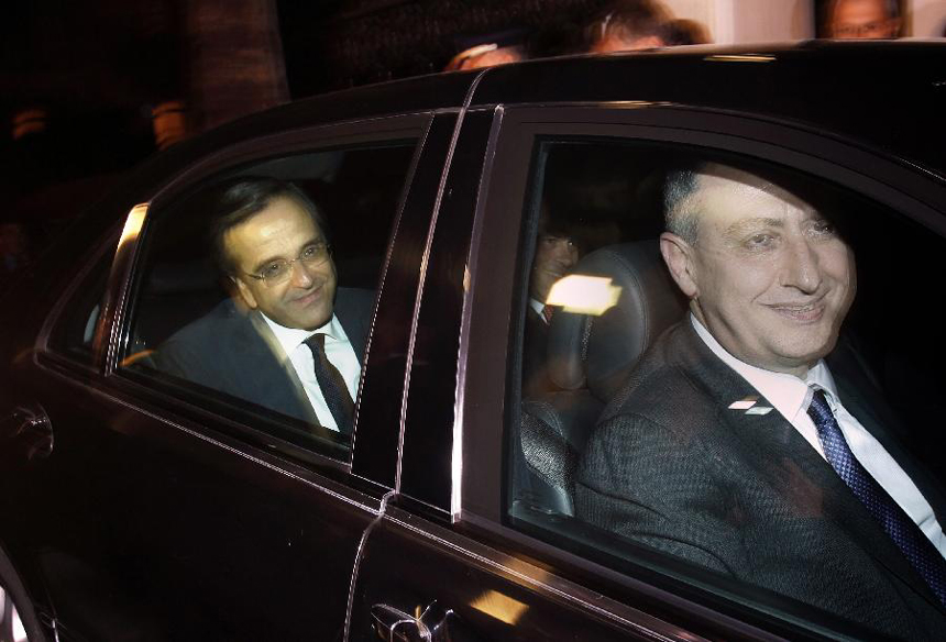 Greek conservative leader Antonis Samaras (L) escorted by party spokesman Yiannis Michelakis (R) smile as they leave the presidential palace after a meeting with President Karolos Papoulias and Greek Prime Minister George Papandreou in Athens November 6, 2011. Papandreou and opposition leader Samaras have agreed on a new coalition government to approve a euro zone bailout deal before elections, the office of the country's president said on Sunday. 