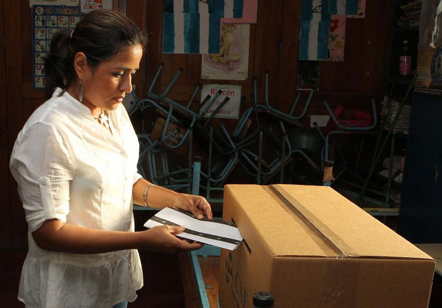 A woman casts her ballot at a polling station in Managua, capital of Nicaragua, Nov. 6, 2011. Nicaraguans went to the polls Sunday to choose their country's president, vice president, 90 deputies of the National Assembly and 20 Central American parliamentarians. 