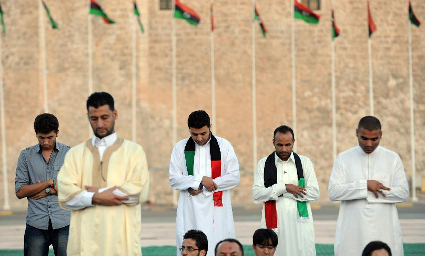 Libyans pray at the Martyrs' Square during Eid al-Adha festival celebration in Tripoli, Libya, Nov. 6, 2011. 